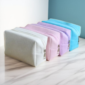 Trousse de maquillage en velours côtelé, grande capacité, disponible en mauve, rose, beige et bleu. Style chic et tendance avec fermeture éclair.
